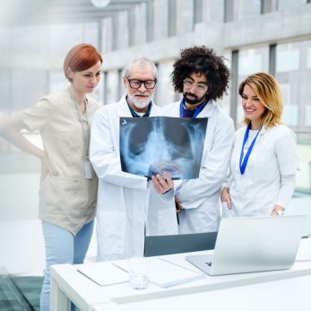 group-of-doctors-talking-about-corona-virus-on-con-XC927K5